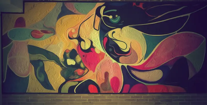 Abstract female figure painted as a large-format interior mural