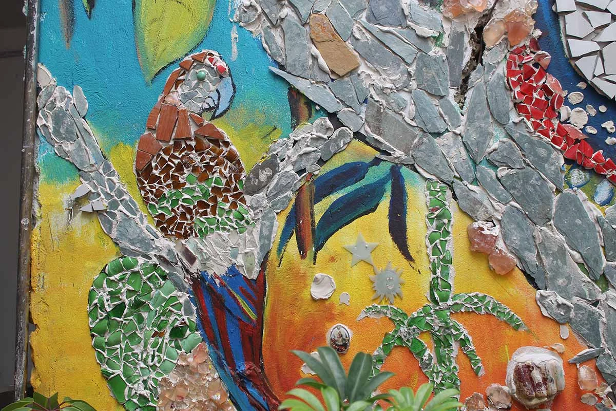 Colorful bird and botanical details made with textured mosaic materials